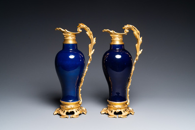 A pair of Chinese monochrome blue vases with gilt bronze ewer mounts, Qianlong and 19th C.
