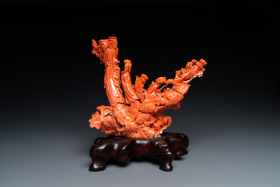 A large Chinese carved red coral group with two ladies surrounded by birds, fish and flowers, 19th C.