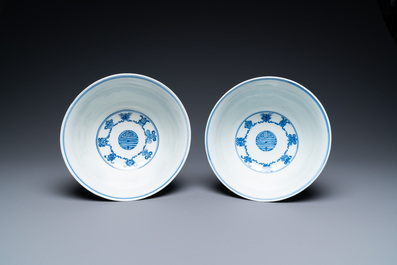 A pair of Chinese blue and white 'wan shou wu jiang' bowls, Qianlong mark and of the period