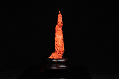 A large Chinese carved red coral 'Guanyin' figure, 19/20th C.