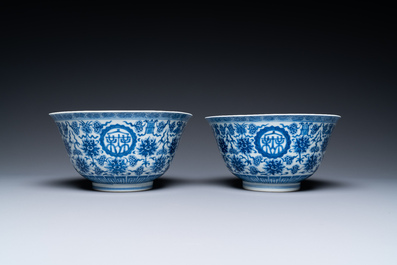 A pair of Chinese blue and white 'wan shou wu jiang' bowls, Qianlong mark and of the period