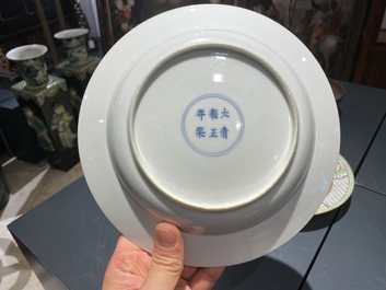 A pair of Chinese famille rose eggshell plates with fine grisaille and gilt designs, Yongzheng mark and of the period