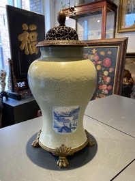 Un vase en porcelaine de Chine en c&eacute;ladon monochrome &agrave; d&eacute;cor incis&eacute; aux panneaux en bleu, blanc et rouge de cuivre, Kangxi