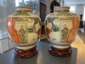A pair of Chinese famille verte vases on wooden stands, 'hare' mark, 19th C.