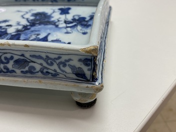 A Dutch Delft blue and white square footed tray on ball feet with chinoiserie design, late 17th C.