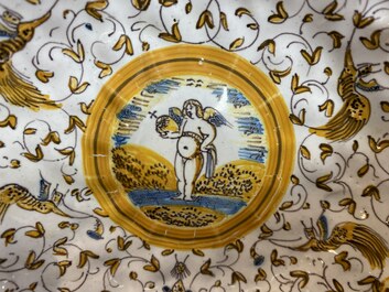 A ribbed polychrome 'grotesque' saucer with a putto holding an orb, Willem Jansz. Verstraeten, Haarlem, 1645-1655