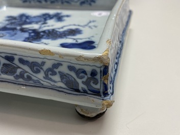 A Dutch Delft blue and white square footed tray on ball feet with chinoiserie design, late 17th C.