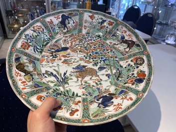A pair of Chinese famille verte 'mythical animals' dishes, seal marks, Kangxi