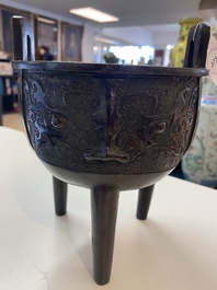 A Chinese bronze tripod censer with 'taotie' masks, Ming