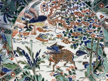A pair of Chinese famille verte 'mythical animals' dishes, seal marks, Kangxi
