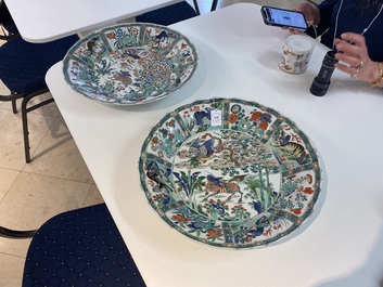 A pair of Chinese famille verte 'mythical animals' dishes, seal marks, Kangxi
