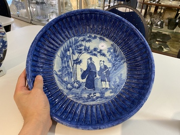 A Chinese ribbed blue and white dish with a scholar and his pupil, 19th C.