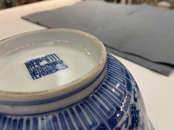 A pair of Chinese blue and white 'wan shou wu jiang' bowls, Qianlong mark and of the period