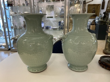 A pair of Chinese monochrome celadon vases with underglaze design on wooden stands, Qianlong mark, 18/19th C.