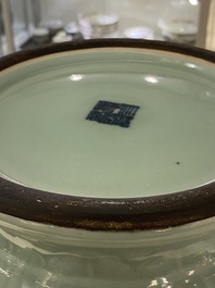 Een paar Chinese monochrome celadon vazen met onderglazuur decor op houten sokkels, Qianlong merk, 18/19e eeuw