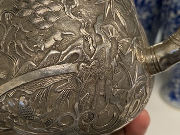 A Chinese silver teapot with birds among blossoming branches, 19th C.
