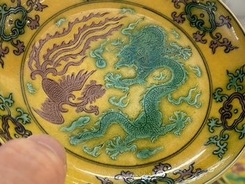 A pair of Chinese yellow-ground turquoise- and aubergine-glazed 'dragon and phoenix' plates, Qianlong mark, 19/20th C.