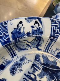 A Chinese blue and white dish with two ladies and two rabbits in a garden, Kangxi mark and of the period