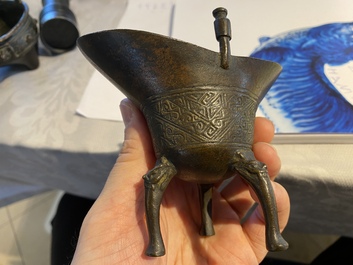 Two Chinese small bronze 'jue' ewers and a tripod censer, probably Yuan