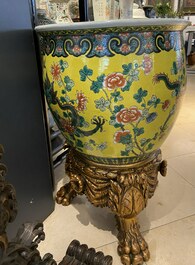 A Chinese yellow-ground famille verte 'dragons' fish bowl on gilded wooden stand, 19th C.