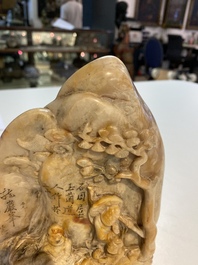 A Chinese Shoushan soapstone seal group depicting figures beneath a mountain, 19th C.