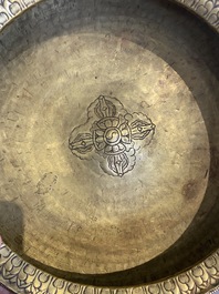 A Tibetan brass ewer, an alms bowl and an Indian bronze ewer, 18/19th C.