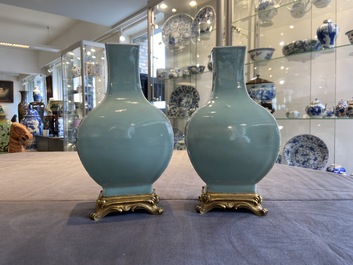 A pair of Chinese monochrome celadon vases with gilt bronze mounts, 18/19th C.