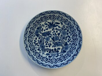 Three Chinese blue and white dishes with dragons, phoenixes and Buddhist lions, 19th C.