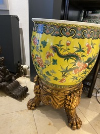 A Chinese yellow-ground famille verte 'dragons' fish bowl on gilded wooden stand, 19th C.