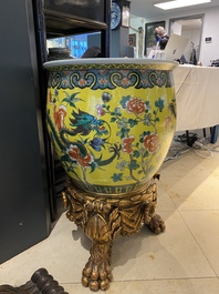 A Chinese yellow-ground famille verte 'dragons' fish bowl on gilded wooden stand, 19th C.