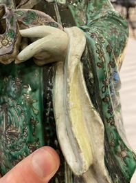 A Chinese verte biscuit figure of an immortal, 19th C.