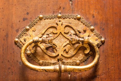 A Spanish walnut 'bargue&ntilde;o' cabinet with red velvet and bronze mounts, 17th C.