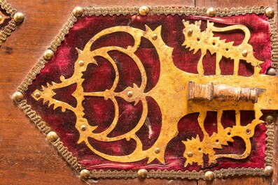 A Spanish walnut 'bargue&ntilde;o' cabinet with red velvet and bronze mounts, 17th C.