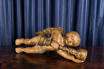 A polychrome wooden sculpture of a putto holding a chalice, 18th C.