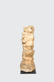 A large stalagmite specimen on a square wooden base