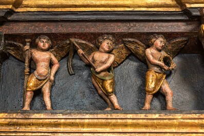 A large Flemish polychrome walnut retable, probably Ghent, dated 1529