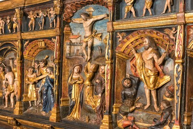 A large Flemish polychrome walnut retable, probably Ghent, dated 1529