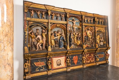 A large Flemish polychrome walnut retable, probably Ghent, dated 1529