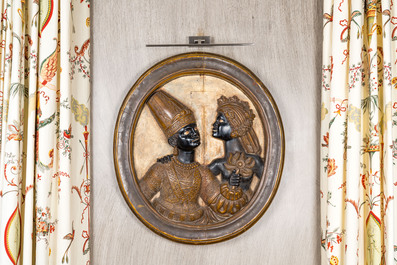 A pair of Italian oval wooden medallions with a Moorish couple, probably Venice, 19th C.