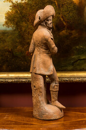 A terracotta figure of a flute player, 19th C.