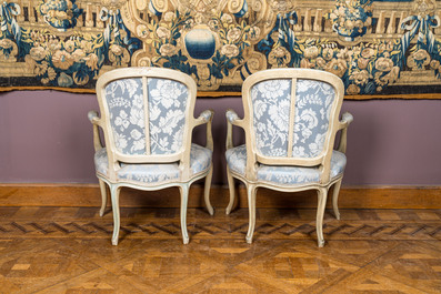 A pair of French Louis XV-style patinated wooden armchairs, 20th C.