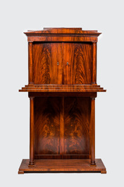 A neoclassical mahogany cabinet on stand, 19th C.