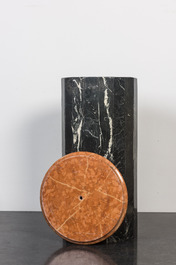 A black marble stand with orange-red marble top, 20th C.