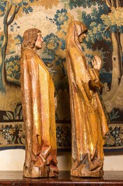 Two large Flemish polychromed and gilt walnut figures of Mary and John the Baptist, Brabant, late 15th C.