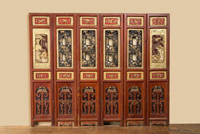 A Chinese six-panel screen in painted, gilt and reticulated wood, 19th C.