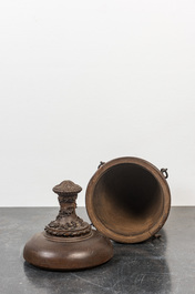 A patinated carved wooden urn and cover, probably France, 19th C.