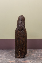 A Spanish walnut figure of John the Baptist, mid 15th C.