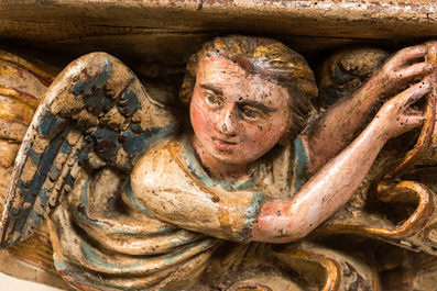 Een groot polychroom houten 'Jeruzalem' reli&euml;f op een console met gevleugelde putto, 19e eeuw