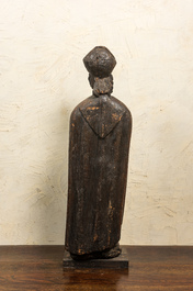 A large wooden sculpture of Saint Nicolas with a kneeling boy, 17th C.