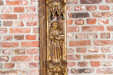 An impressive Gothic Revival carved and gilt wood frame with monks under canopies, 19th C.